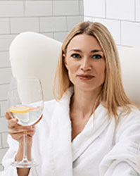 Woman in robe relaxes and enjoys her custom crafted wellness IV infusions.