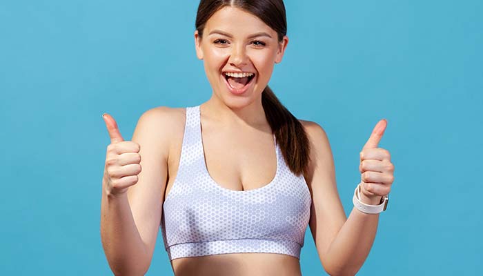 Happy woman give the thumbs up for weight loss coaching provided by Wellness and Aesthetics by WHEN in Wisconsin.